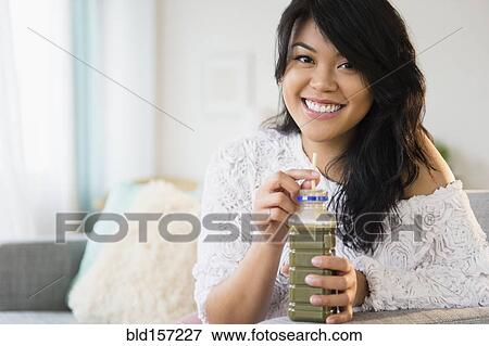 Stock Photo - Pacific Islander woman drinking green juice. Fotosearch