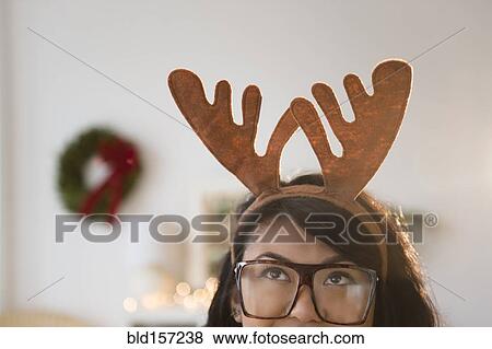 Pacific Islander woman wearing Christmas reindeer horns View Large Photo Image Stock Photo - Pacific Islander woman wearing Christmas reindeer horns. Fotosearch