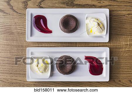 Platters of chocolate souffle dessert with ice cream and sauce View Large Photo Image Stock Image - Platters of chocolate souffle dessert with ice cream and sauce. Fotosearch