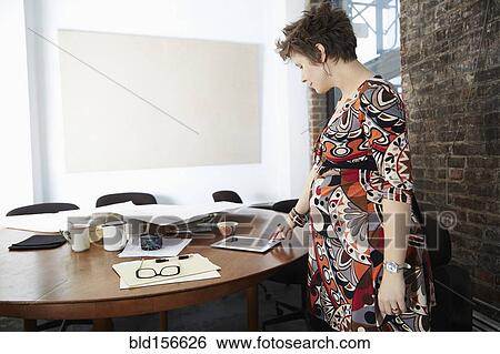 Pregnant businesswoman using digital tablet in office View Large Photo Image Stock Photograph - Pregnant businesswoman using digital tablet in office. Fotosearch