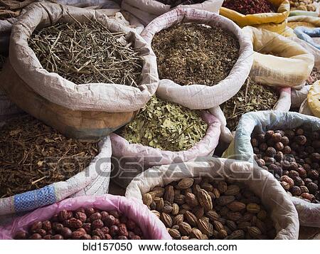 Stock Image - Sacks of dried spices for sale in market. Fotosearch