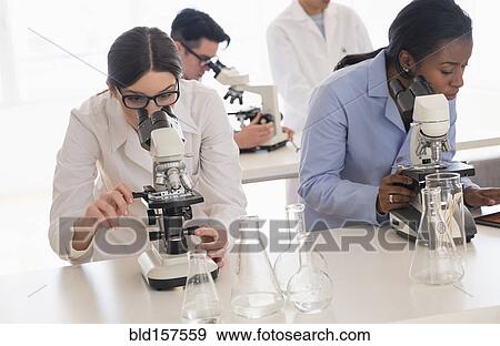 Stock Photo - Scientists using microscopes in research laboratory. Fotosearch