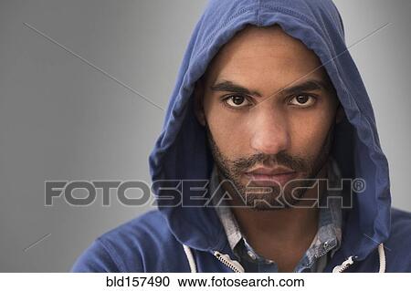 Serious Hispanic man wearing hoodie View Large Photo Image Stock Image - Serious Hispanic man wearing hoodie. Fotosearch