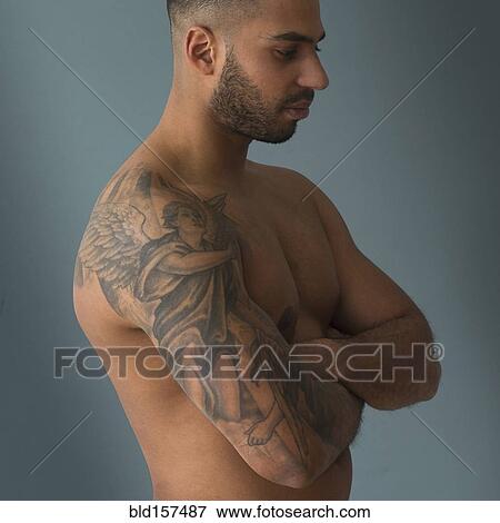 Stock Photo - Shirtless Hispanic man with tattoos. Fotosearch