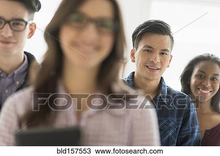 Stock Image - Smiling businessman in office. Fotosearch
