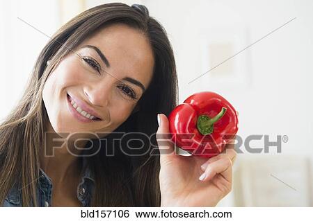 Smiling Caucasian woman holding red pepper View Large Photo Image Stock Photograph - Smiling Caucasian woman holding red pepper. Fotosearch