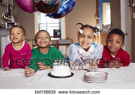 Smiling children with cake at party View Large Photo Image Stock Photography - Smiling children with cake at party. Fotosearch