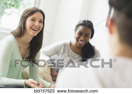 Smiling friends talking View Large Photo Image Stock Image - Smiling friends talking. Fotosearch