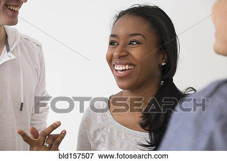 Stock Photo - Smiling friends talking. Fotosearch