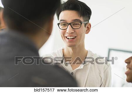 Smiling friends talking View Large Photo Image Stock Photo - Smiling friends talking. Fotosearch