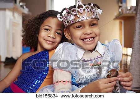 Picture - Smiling girls playing dress-up. Fotosearch
