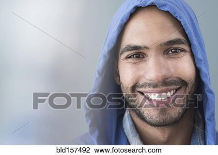 Smiling Hispanic man wearing hoodie View Large Photo Image Stock Image - Smiling Hispanic man wearing hoodie. Fotosearch