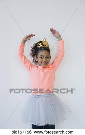 Smiling mixed race ballerina posing in tiara View Large Photo Image Stock Photograph - Smiling mixed race ballerina posing in tiara. Fotosearch