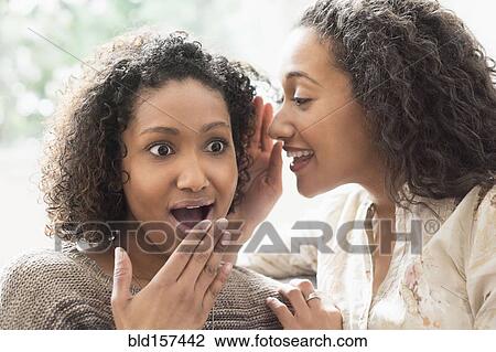 Surprised women whispering secrets View Large Photo Image Stock Image - Surprised women whispering secrets. Fotosearch