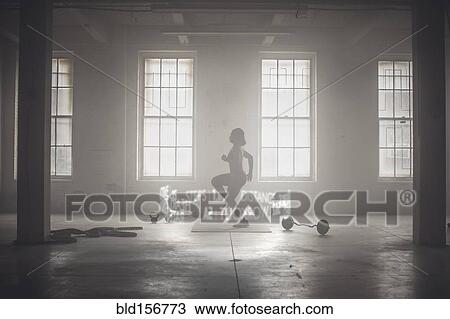 Stock Image - Virtual words circling Black athlete while working out. Fotosearch