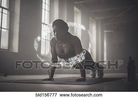 Virtual words circling Black athlete doing push-ups View Large Photo Image Stock Photo - Virtual words circling Black athlete doing push-ups. Fotosearch