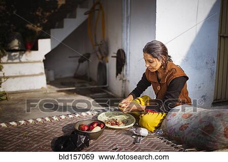 Woman preparing food outdoors View Large Photo Image Stock Photo - Woman preparing food outdoors. Fotosearch