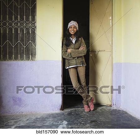 Woman smiling and leaning in doorway View Large Photo Image Stock Image - Woman smiling and leaning in doorway. Fotosearch