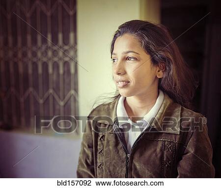 Stock Image - Woman smiling outdoors. Fotosearch