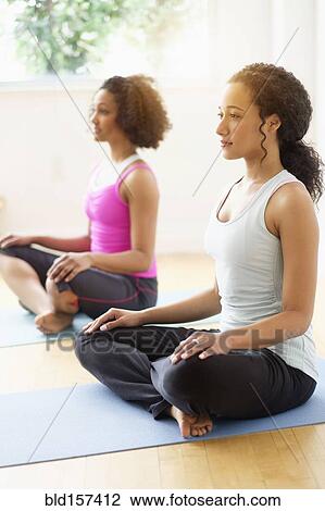 Women meditating in yoga class View Large Photo Image Stock Image - Women meditating in yoga class. Fotosearch