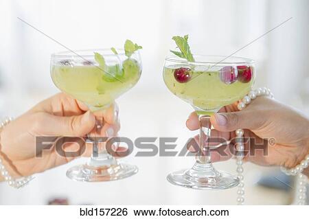 Women toasting with cocktails and pearl necklaces View Large Photo Image Stock Photograph - Women toasting with cocktails and pearl necklaces. Fotosearch