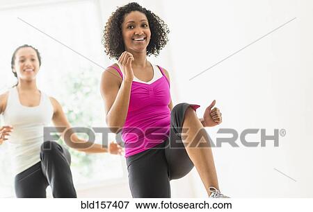 Women working out in exercise class View Large Photo Image Stock Photo - Women working out in exercise class. Fotosearch