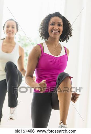 Women working out in exercise class View Large Photo Image Stock Photograph - Women working out in exercise class. Fotosearch