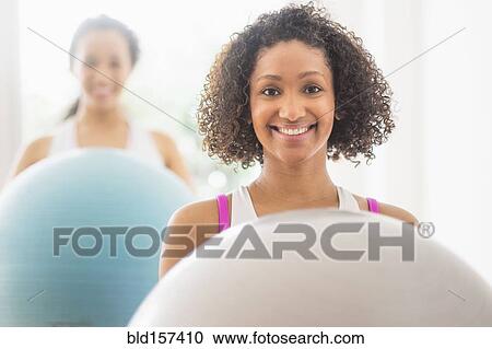 Women working out with fitness balls in exercise class View Large Photo Image Stock Image - Women working out with fitness balls in exercise class. Fotosearch