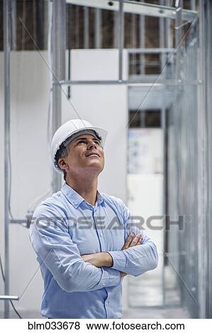 Caucasian architect admiring construction site View Large Photo Image Stock Photo - Caucasian architect admiring construction site. Fotosearch