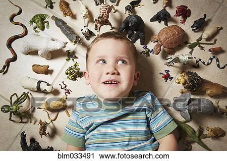 Caucasian boy surrounded near toy animals View Large Photo Image Stock Image - Caucasian boy surrounded near toy animals. Fotosearch