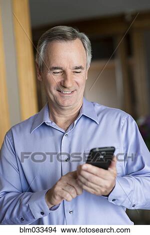 Caucasian businessman using cell phone View Large Photo Image Picture - Caucasian businessman using cell phone. Fotosearch