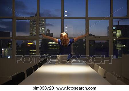 Caucasian businesswoman cheering at laptop in office at night View Large Photo Image Stock Image - Caucasian businesswoman cheering at laptop in office at night. Fotosearch