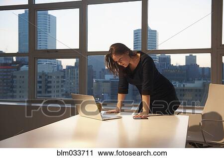Caucasian businesswoman using laptop in office View Large Photo Image Stock Image - Caucasian businesswoman using laptop in office. Fotosearch