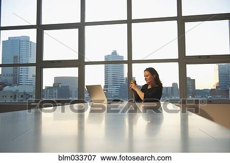 Caucasian businesswoman using laptop in office View Large Photo Image Stock Photo - Caucasian businesswoman using laptop in office. Fotosearch