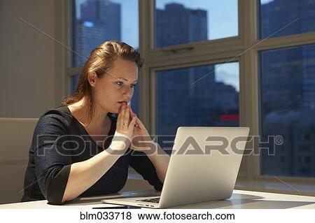 Caucasian businesswoman using laptop in office View Large Photo Image Stock Photo - Caucasian businesswoman using laptop in office. Fotosearch