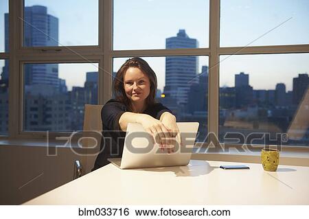 Caucasian businesswoman using laptop in office View Large Photo Image Stock Photograph - Caucasian businesswoman using laptop in office. Fotosearch