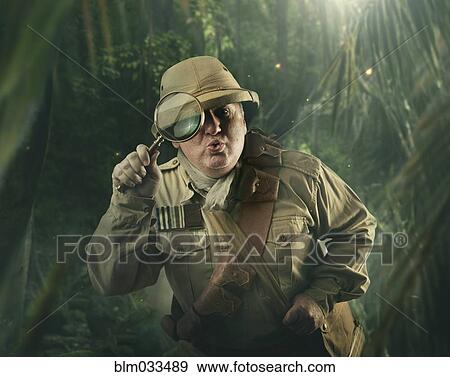 Caucasian hunter peering through magnifying glass in jungle View Large Photo Image Stock Photo - Caucasian hunter peering through magnifying glass in jungle. Fotosearch