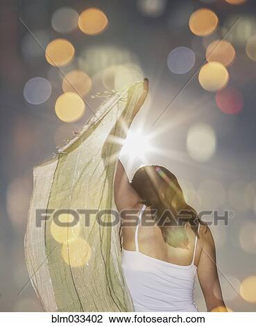 Stock Image - Caucasian woman waving scarf. Fotosearch