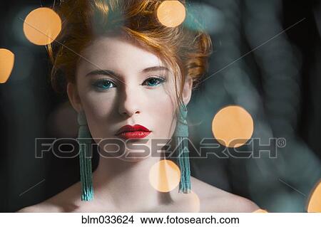 Picture - Caucasian woman with glamorous make-up and earrings. Fotosearch