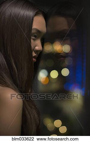 Stock Image - Close up of Asian woman with long hair. Fotosearch