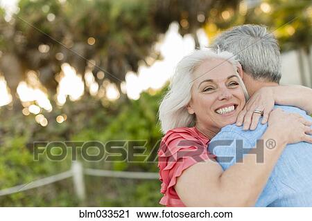 Stock Image - Close up of older Caucasian couple hugging. Fotosearch