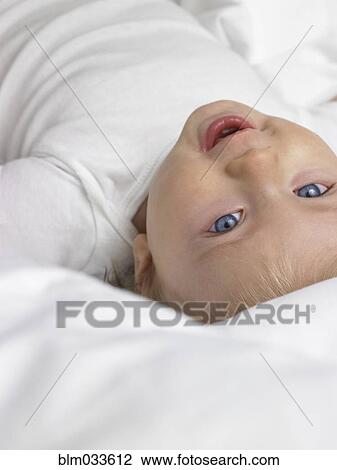 Stock Image - High angle view of smiling mixed race baby girl. Fotosearch