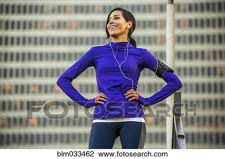 Hispanic runner standing near highrise building View Large Photo Image Stock Image - Hispanic runner standing near highrise building. Fotosearch