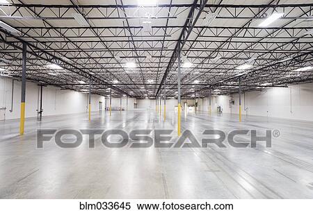 Stock Photography - Infrastructure and lighting in empty warehouse. Fotosearch
