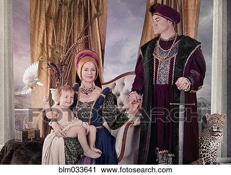 Stock Image - Medieval couple and child posing in living room. Fotosearch