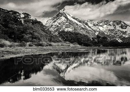 Mountains reflecting in remote lake, Key Summit, Southland, New Zealand View Large Photo Image Stock Image - Mountains reflecting in remote lake, Key Summit, Southland, New Zealand. Fotosearch