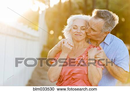 Older Caucasian couple kissing on beach View Large Photo Image Stock Image - Older Caucasian couple kissing on beach. Fotosearch
