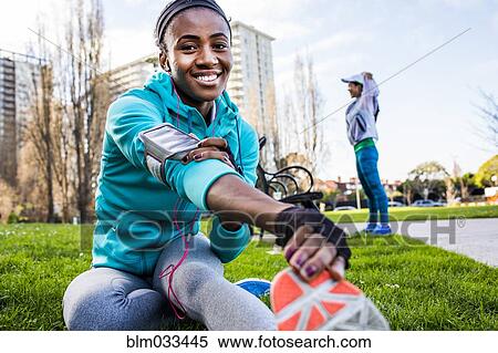 Stock Photography - Runner stretching in urban park. Fotosearch