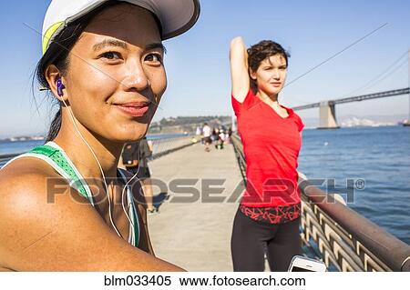 Stock Photography - Runner stretching on urban footbridge, San Francisco, California, United States. Fotosearch