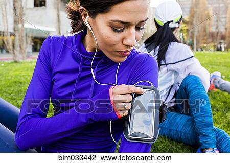 Runner using cell phone in urban park View Large Photo Image Stock Image - Runner using cell phone in urban park. Fotosearch